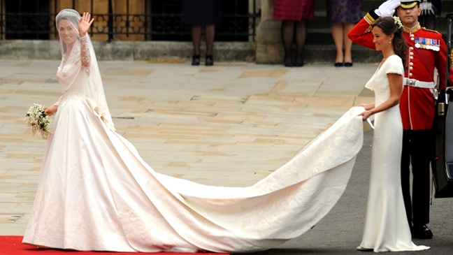 Kate Middleton (L) waves as she arrives