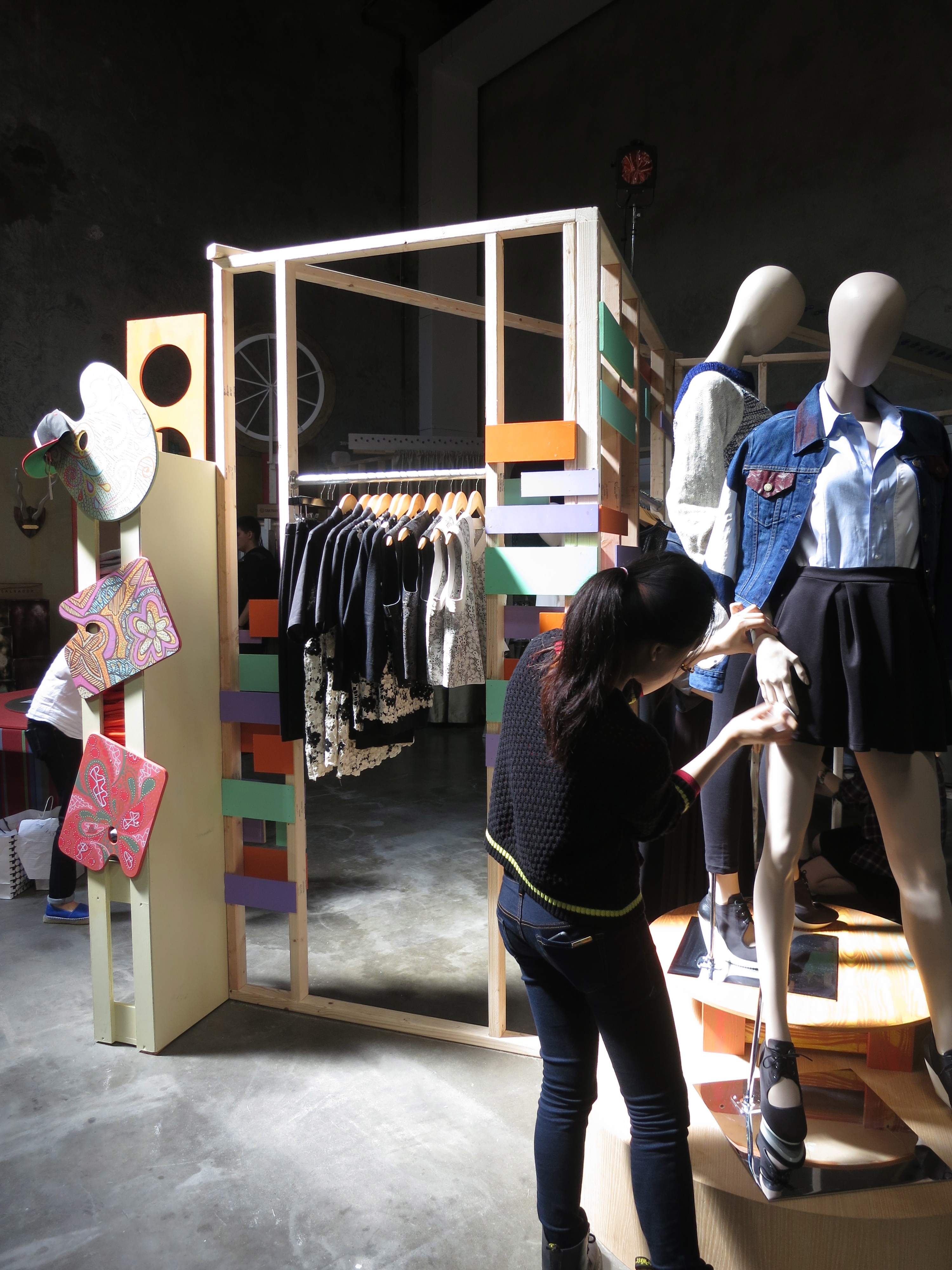 A Fashion Merchandising student puts the final touches on a display before the opening. Photo by Martin Zanfardino
